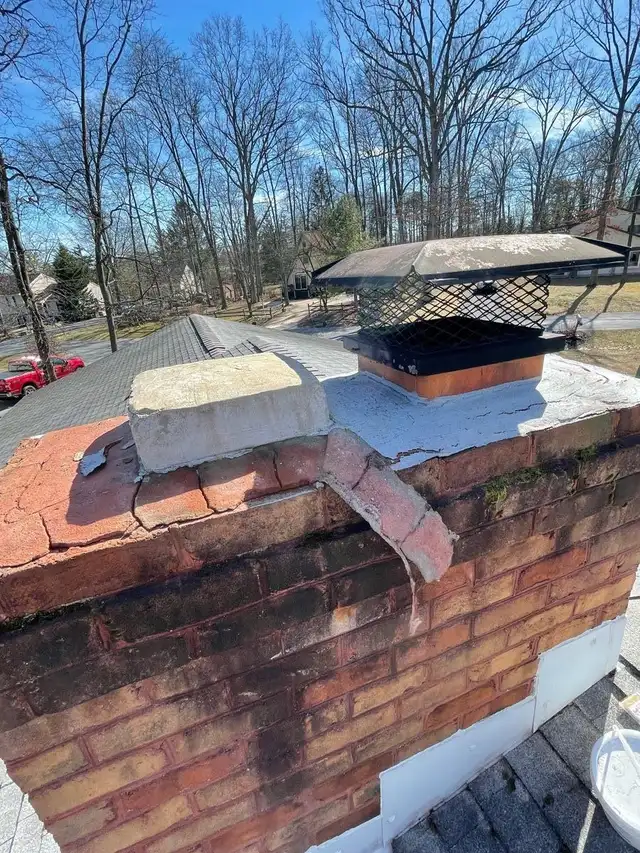 Before: a crumbled concrete crown and black mesh cap on a brick chimney